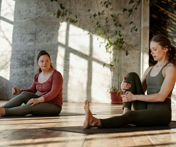 Person stretching in a bright, sunlit room, feeling energized.